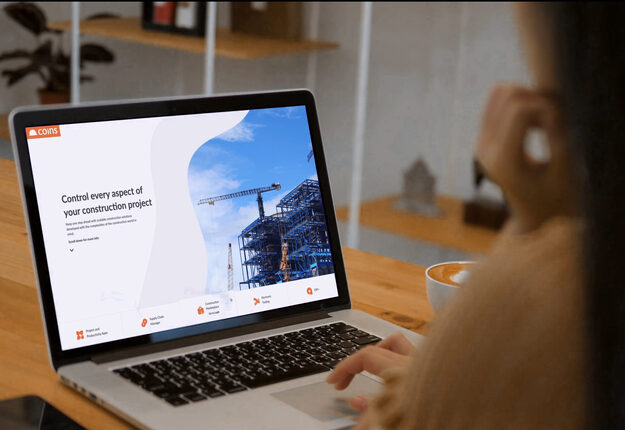 COINS construction software displayed on laptop screen.